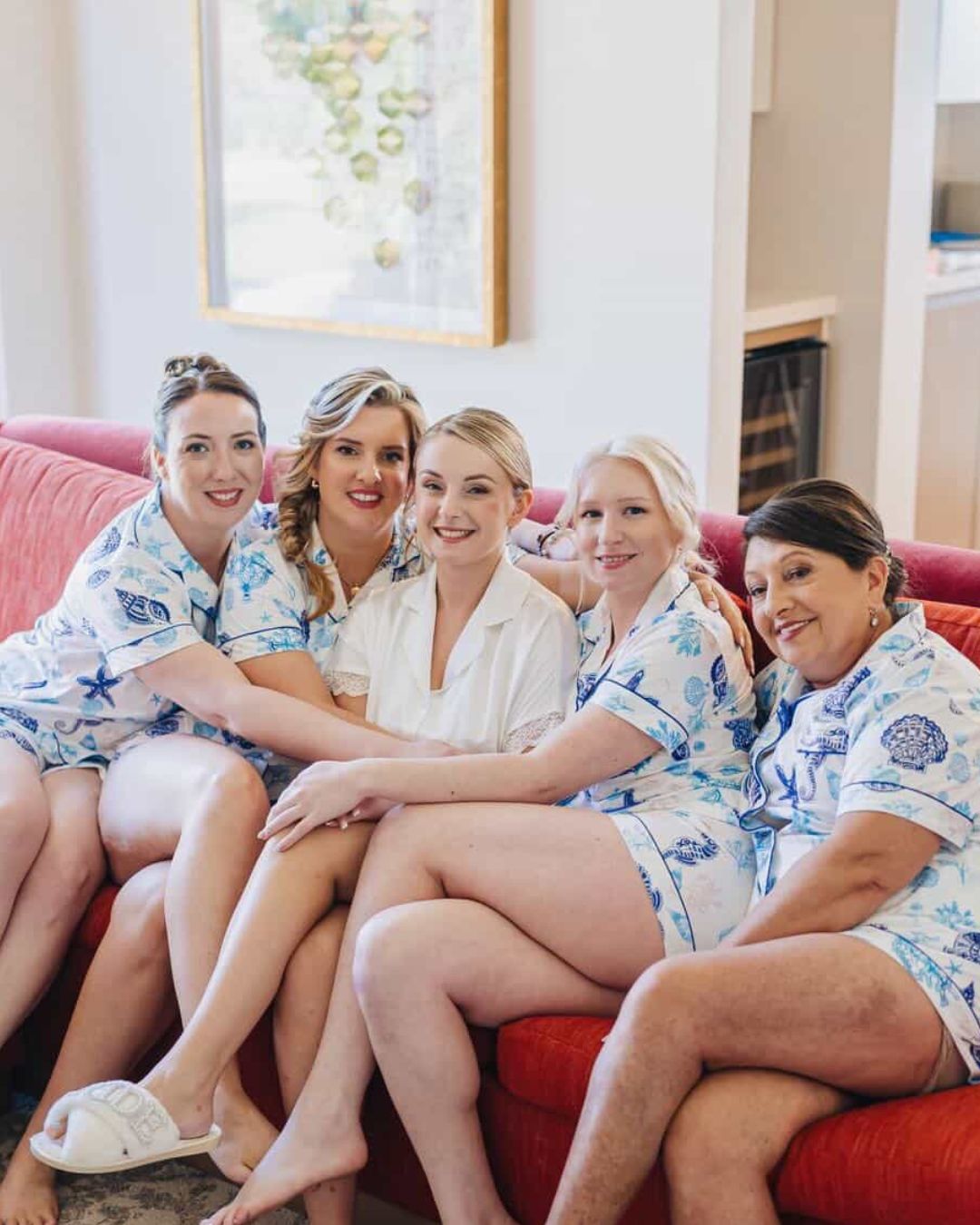 Bride, bridesmaids and mother in matching seashell pajamas on her wedding morning